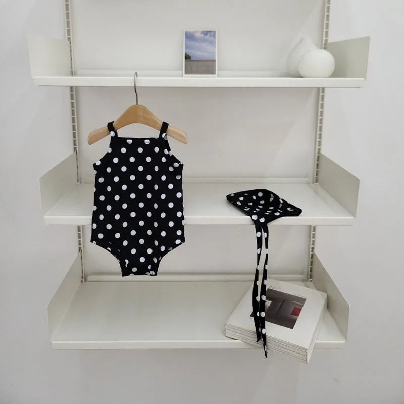 Baby girl swimwear set by Baby Bubble, one-piece swimsuit with matching sun hat, featuring colorful patterns and ruffled details.