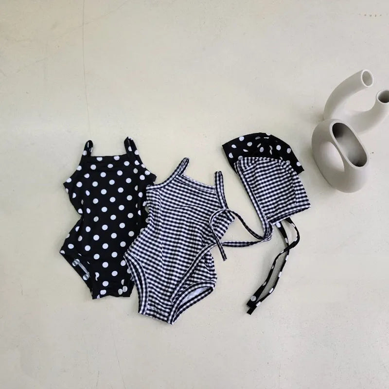 Baby girl swimwear set with one-piece swimsuit and sun hat, featuring colorful patterns and soft fabric for summer swimming.
