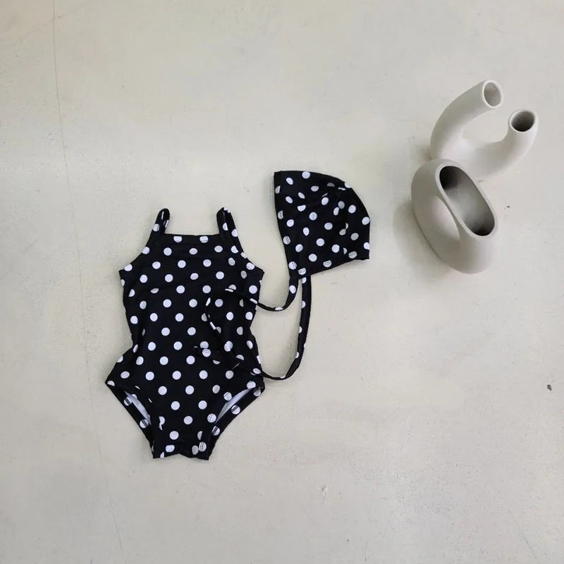 Baby girl swimwear set with one-piece swimsuit and sun hat, Baby Bubble brand, featuring colorful floral patterns and sun protection.