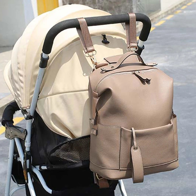 Large leather diaper bag backpack by Baby Bubble with multiple compartments and stylish design for parents on the go.