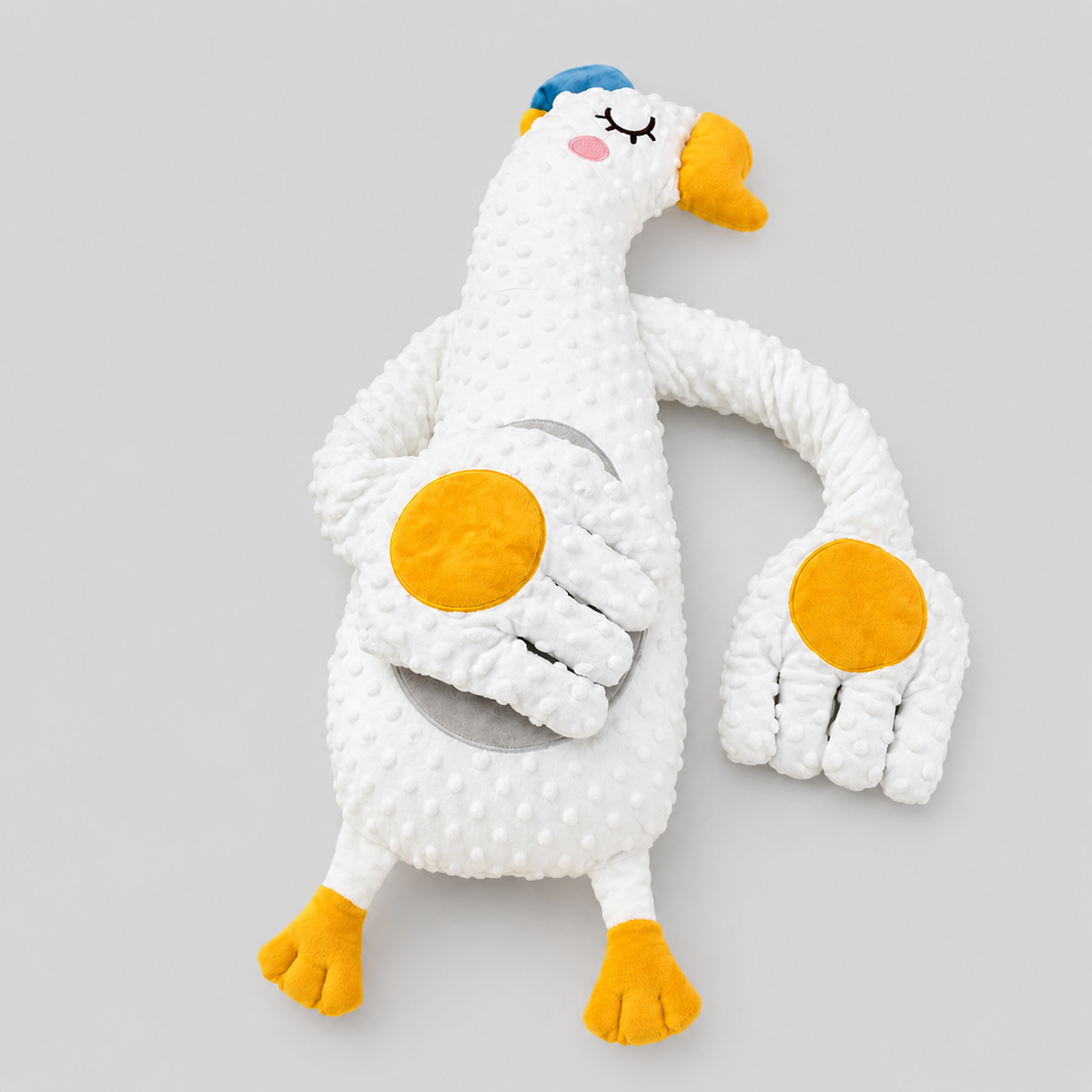 Baby patting pillow with remote control, soft fabric, and calming features for gentle baby sleep support.