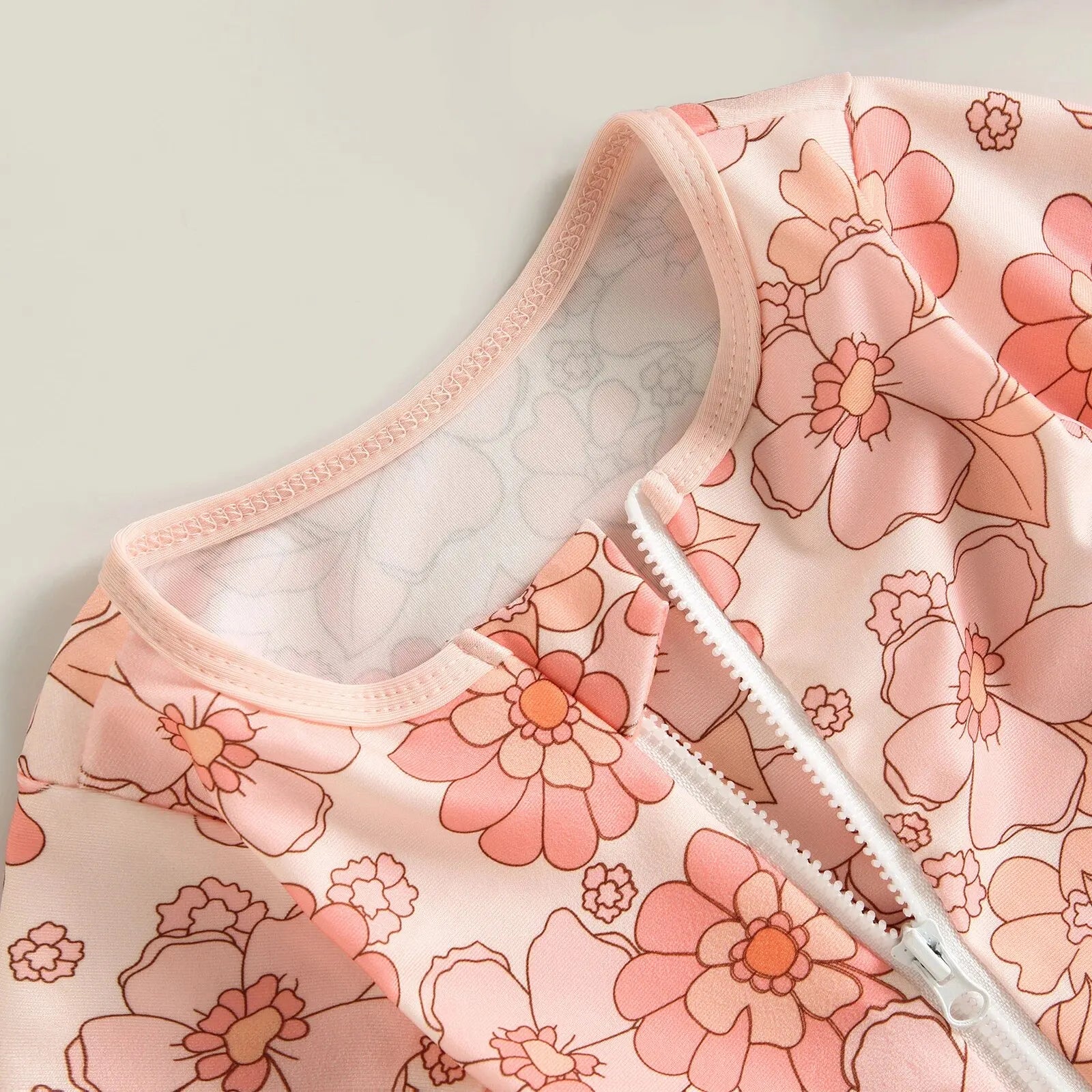 Baby Girl one-piece swimsuit by Baby Bubble with a floral flamingo print, featuring bright colors and a comfortable fit.