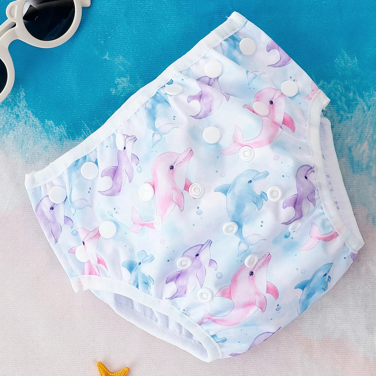 Baby Bubble washable baby swim diapers with adjustable fit, shown in a close-up image featuring colorful waterproof fabric.
