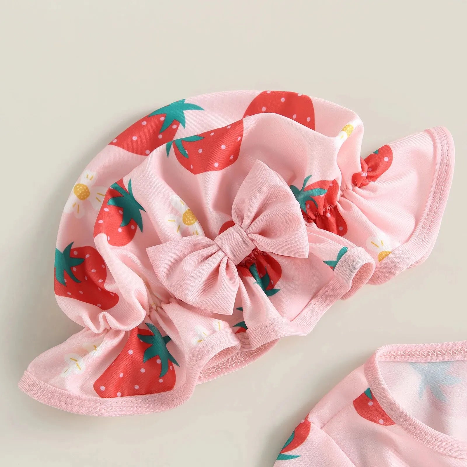 Baby girl one-piece swimsuit with floral flamingo print, featuring colorful tropical design by Baby Bubble.