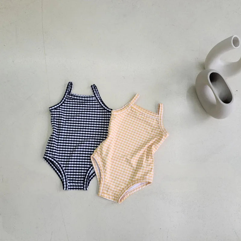 Baby girl swimwear set with one-piece swimsuit and sun hat, Baby Bubble brand, featuring colorful patterns and sun protection.