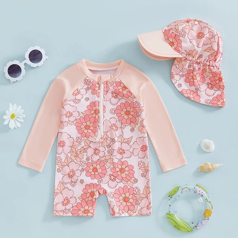 Baby girls rash guard set by Baby Bubble featuring floral and flamingo print, with short sleeves and matching swim bottoms.