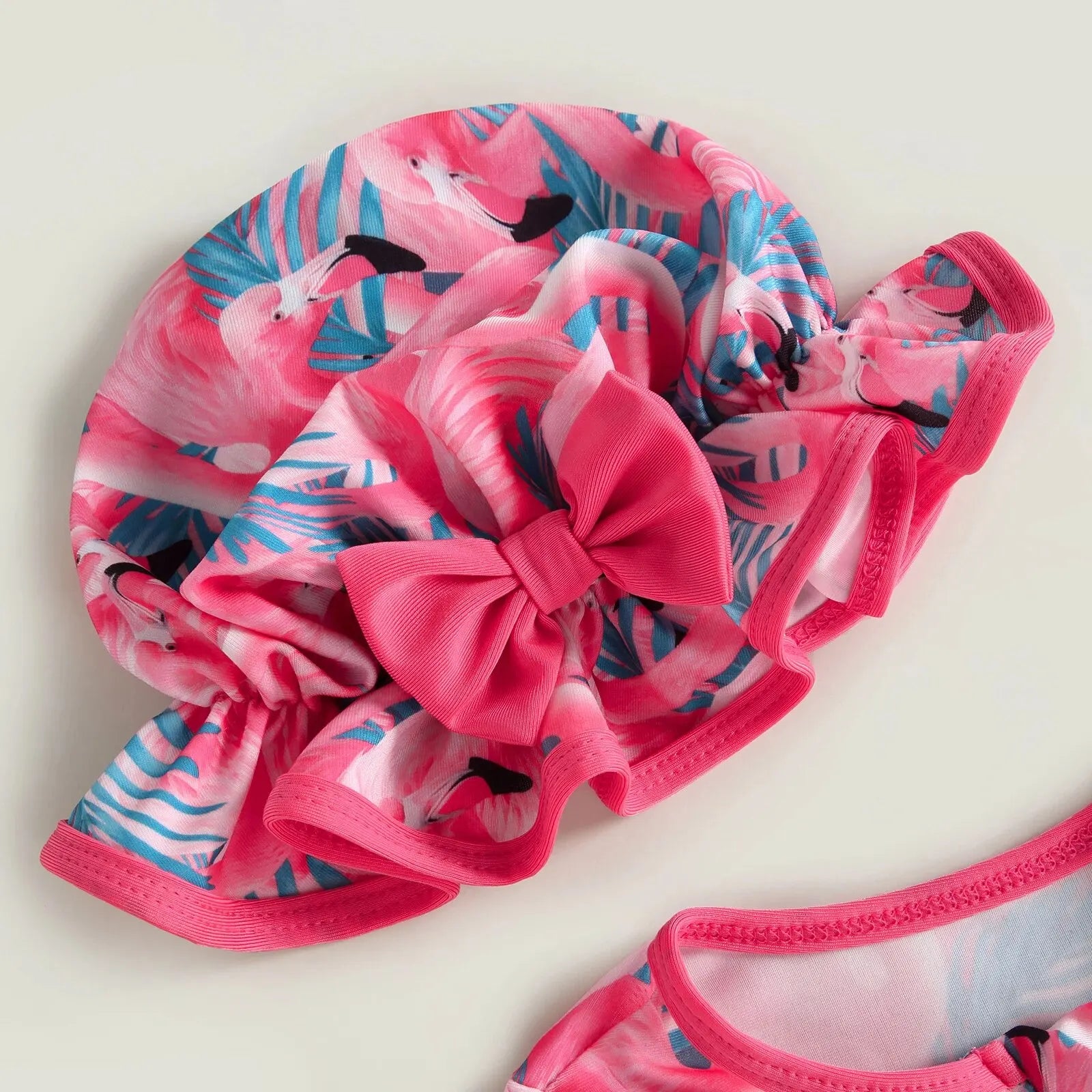 Baby Girl one-piece swimsuit by Baby Bubble with floral flamingo print, featuring bright colors and comfortable fabric for summer fun.