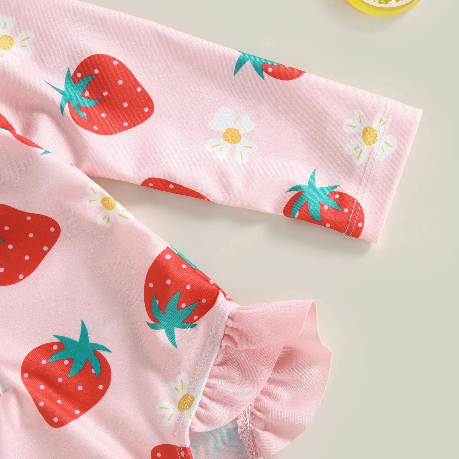 Baby girl one-piece swimsuit with floral flamingo print by Baby Bubble, featuring colorful tropical design and adjustable straps.