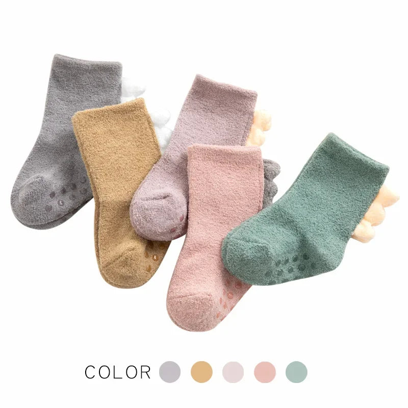 Soft, warm baby dinosaur socks by Baby Bubble featuring colorful dinosaur patterns on cozy baby socks.