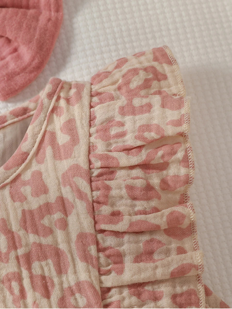 Baby girl in pink summer jumpsuit with bow and headband set, stylish Baby Bubble outfit for warm weather.